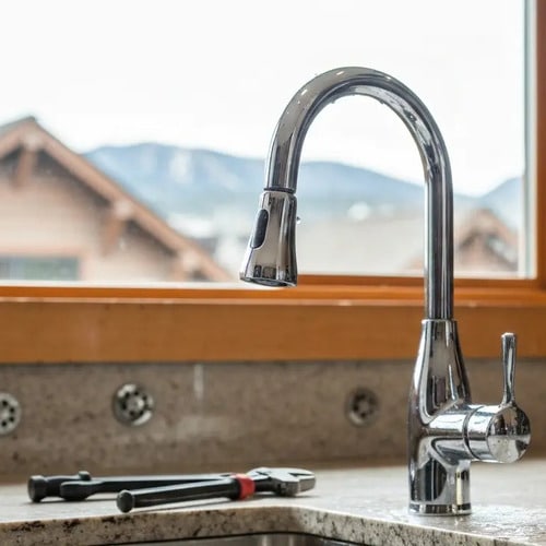 tools next to a kitchen faucet