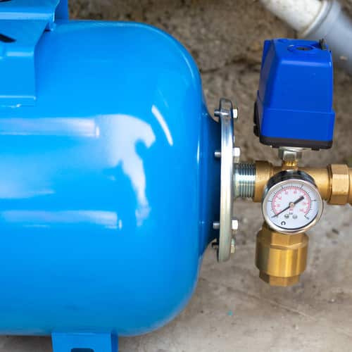 blue water booster pump on a concrete floor