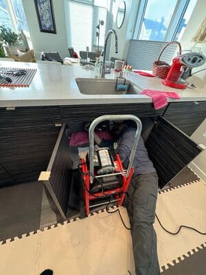 a plumber under a sink