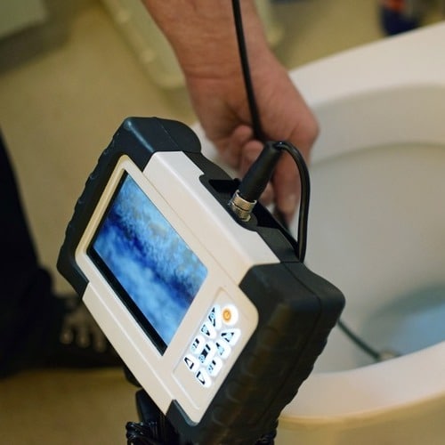 plumber using equipment to perform an inspection