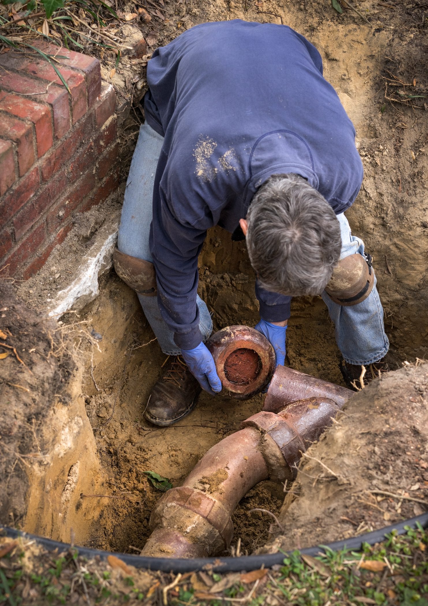 plumber performing sewer line repairs