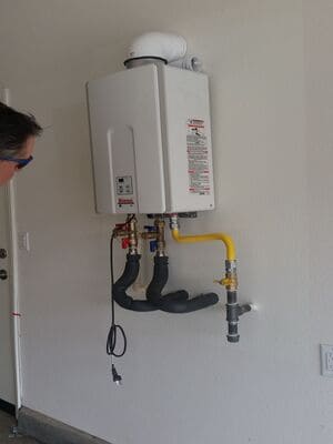 tankless water heater against a wall